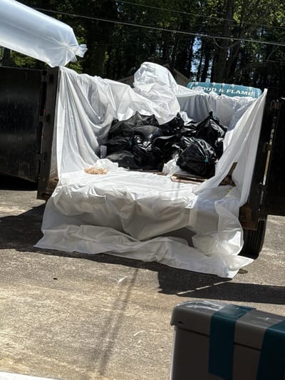The disposal dumpster of bagged waste hauled off the job