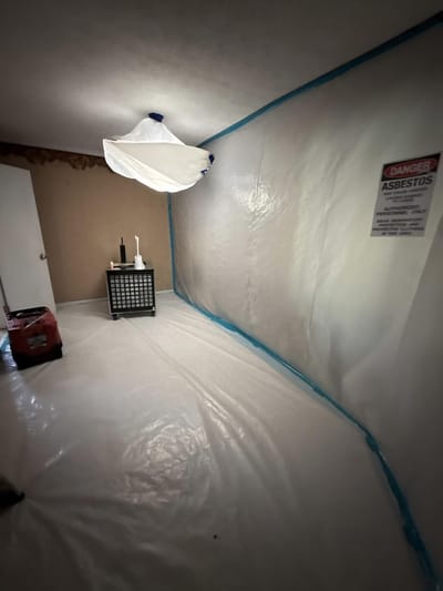 The room sealed in poly containment before demolition began