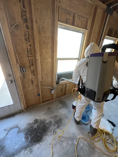 HEPA-vacuuming soot from the framing during the top-to-bottom cleaning