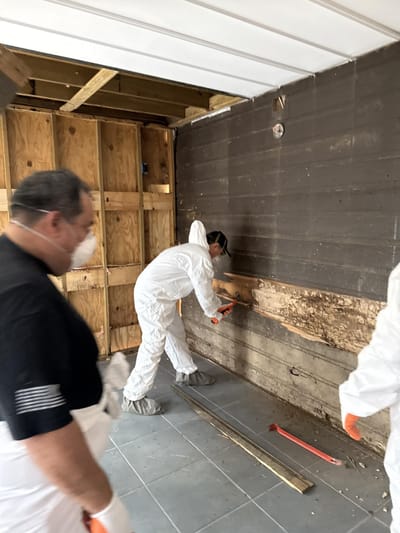 Charred structural studs being removed for replacement