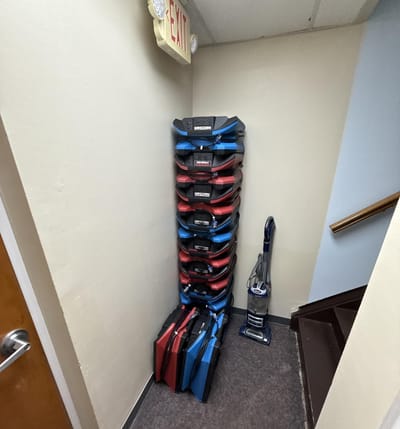 Air movers stacked out of the way in a back corner during business hours